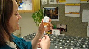 Pharmacist filling prescription bottle